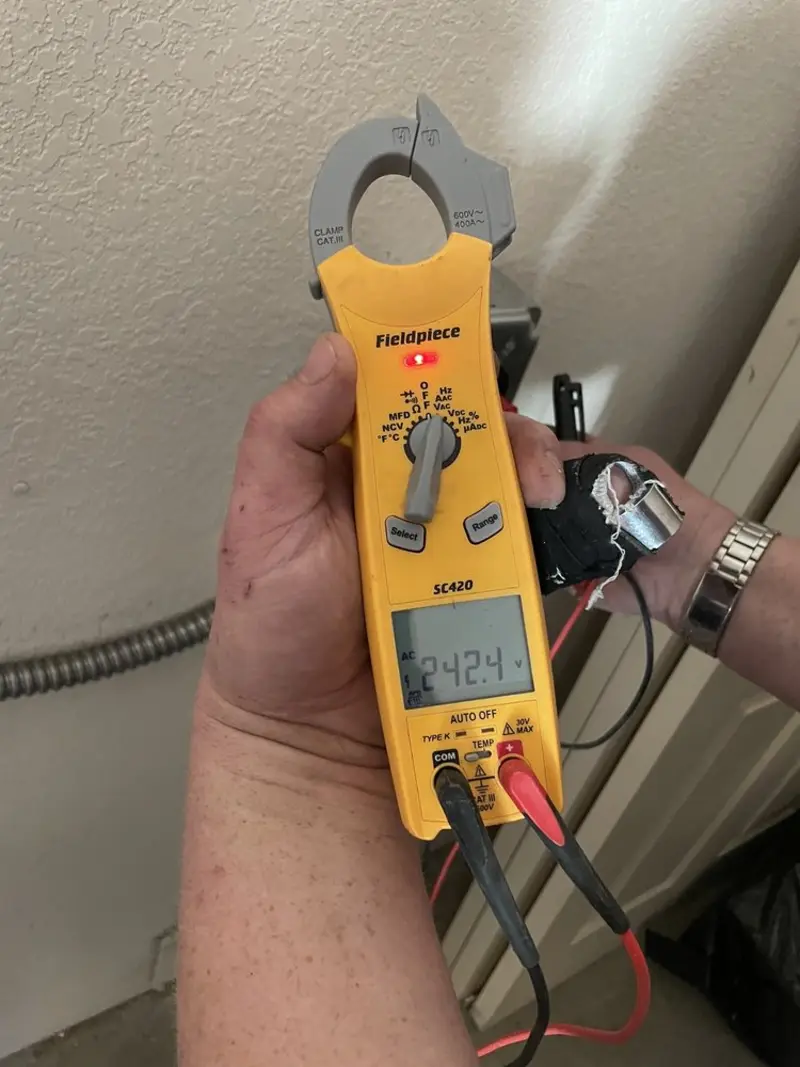 Voltage testing with clamp meter during Recessed Lighting Installation in Elmwood Park